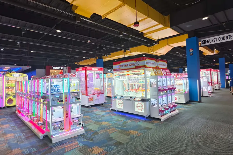 Coin pusher integrated into claw machine boutique
