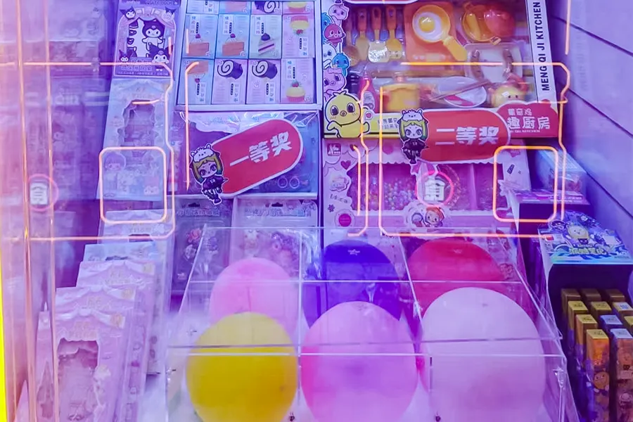 Specialty crane game with ring toss dice or ball drop mechanism close-up